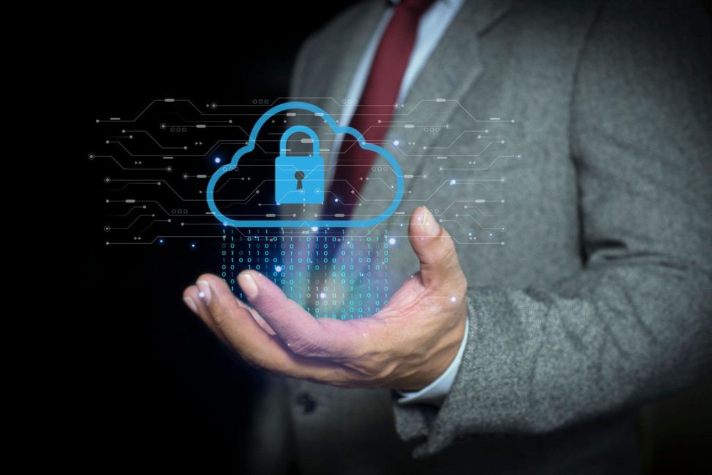 Business professional holding a glowing cloud with a lock symbol, representing the perceived security of cloud-stored data that may not actually be backed up locally.”